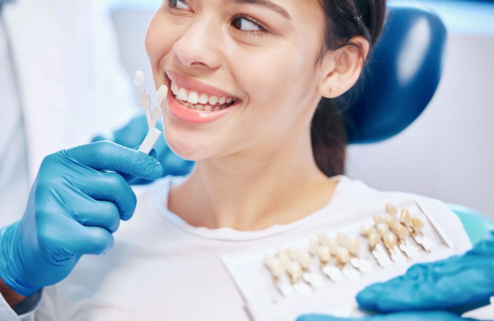 A smiling patient showing perfect teeth after getting dental veneers